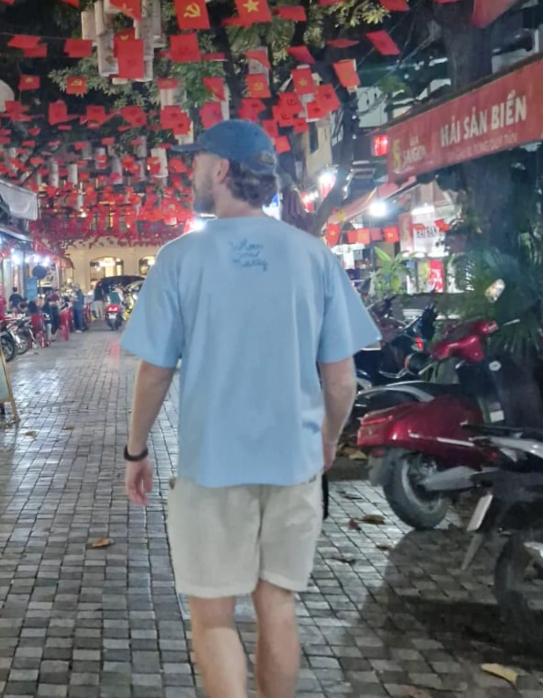 DropSync's founder walking through a street market in South East Asia